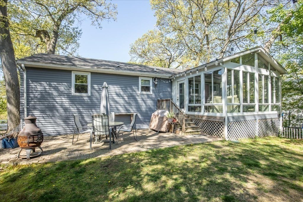 142 Spring Street Stoneham, MA 02180 - Photo 8 of 27 a view of a chair and table in backyard of the house