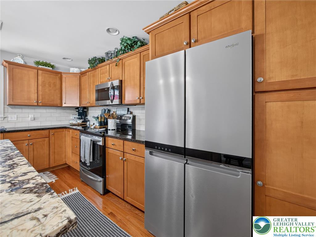 4148 Ross Road Bethlehem, PA 18020 - Photo 40 of 67 Granite counters and hardwood floors define this inviting kitchen space.