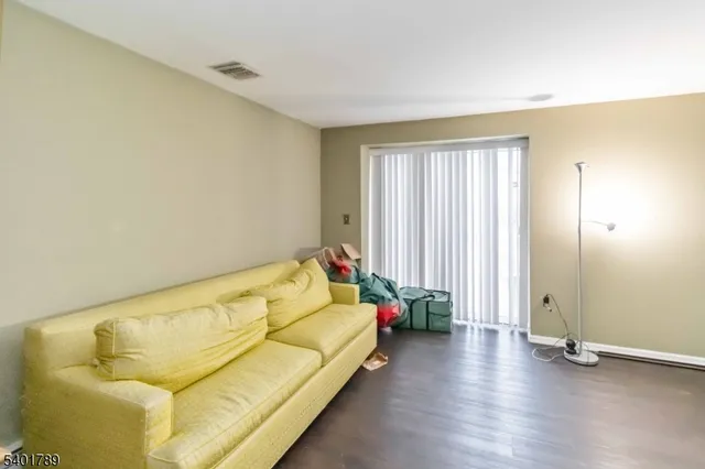 a bed sitting in a spacious bedroom next to a window