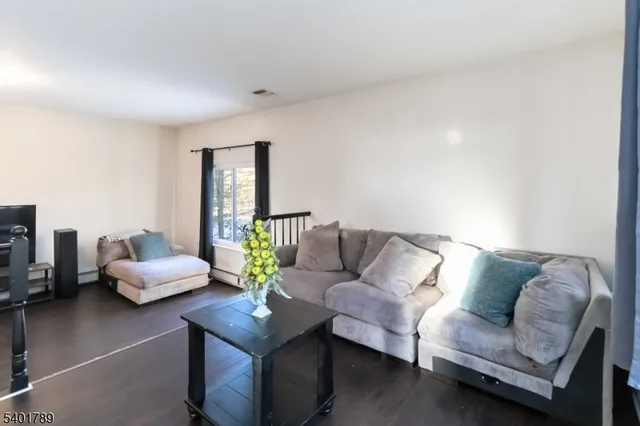 a living room with furniture and stairs