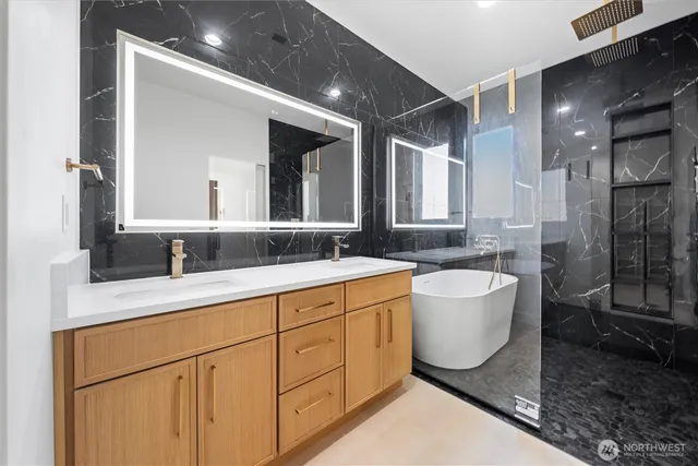 a spacious bathroom with a granite countertop sink mirror and bathtub
