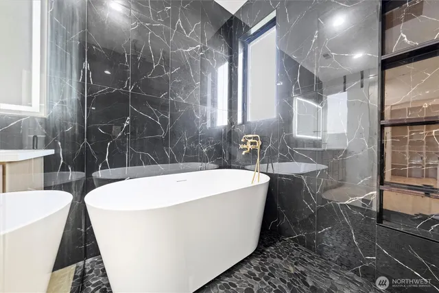 a white bath tub sitting in a bathroom