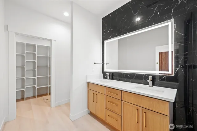 a bathroom with a double vanity sink and a mirror