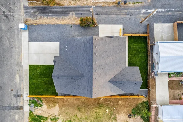 an aerial view of a house with a yard