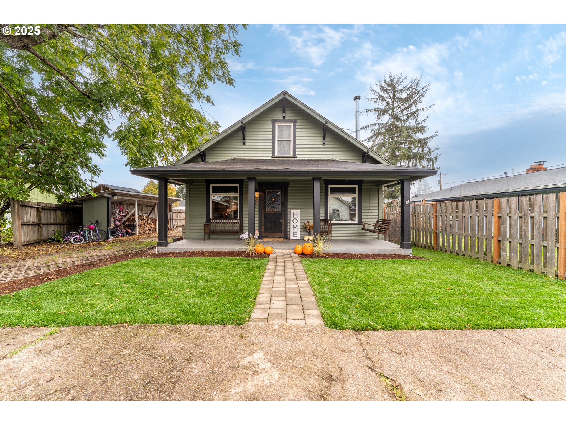 a front view of a house with yard patio and green space
