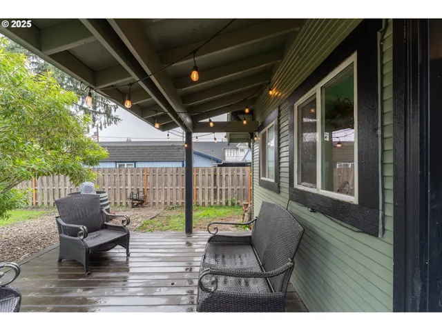 a view of a porch with furniture and a yard