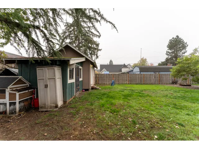 a view of a barn in the back yard