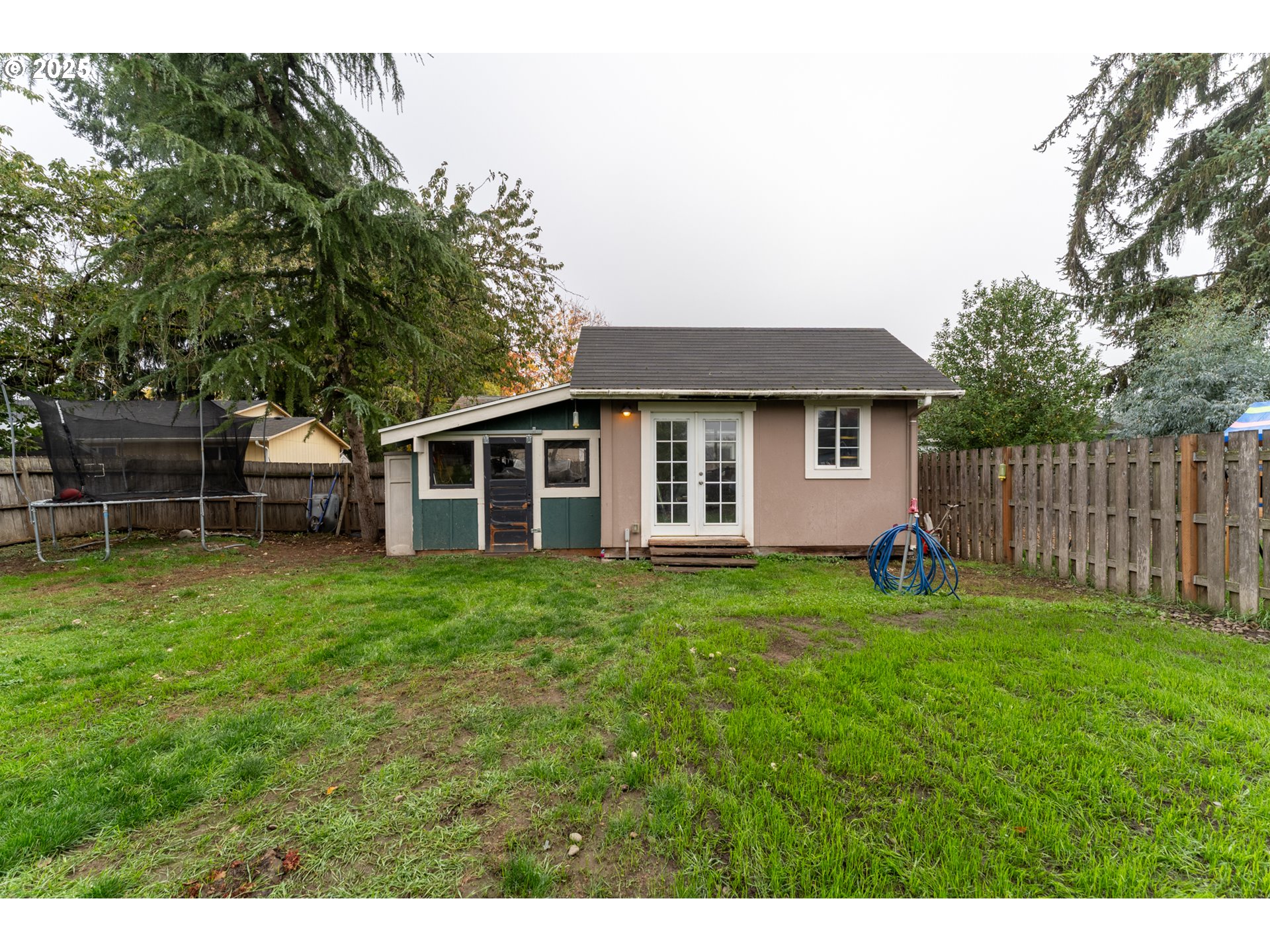 607 Getchell Avenue Amity, OR 97101 - Photo 31 of 33 a view of a backyard with table and chairs and wooden fence