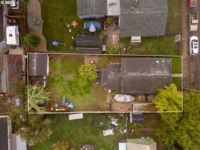 an aerial view of a house with a yard