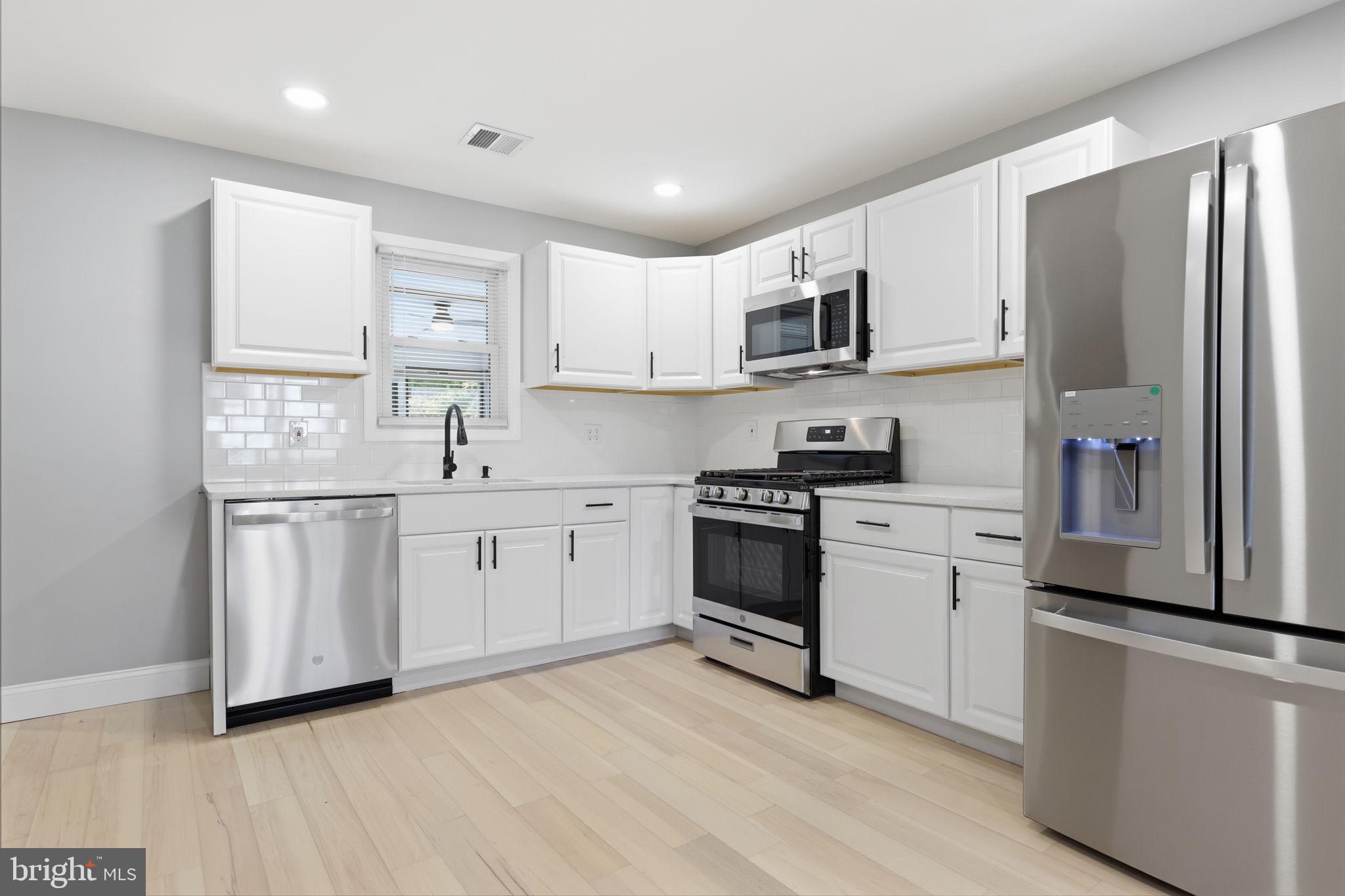 340 West Broad Street Hatfield, PA 19440 - Photo 12 of 55 a kitchen with white cabinets and stainless steel appliances