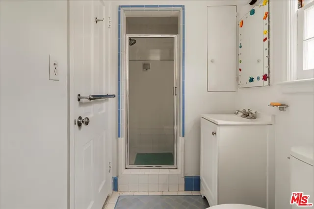 a bathroom with a shower and a sink