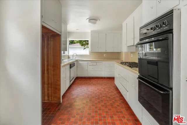 a kitchen with granite countertop stainless steel appliances and wooden cabinets