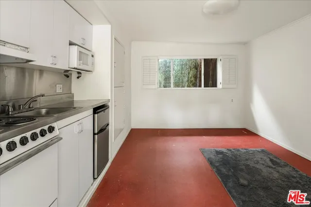 a view of a kitchen with a stove top oven