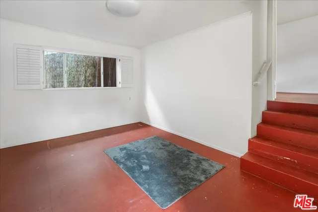 a view of an empty room with stairs