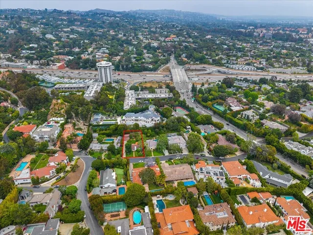 an aerial view of residential houses with city view