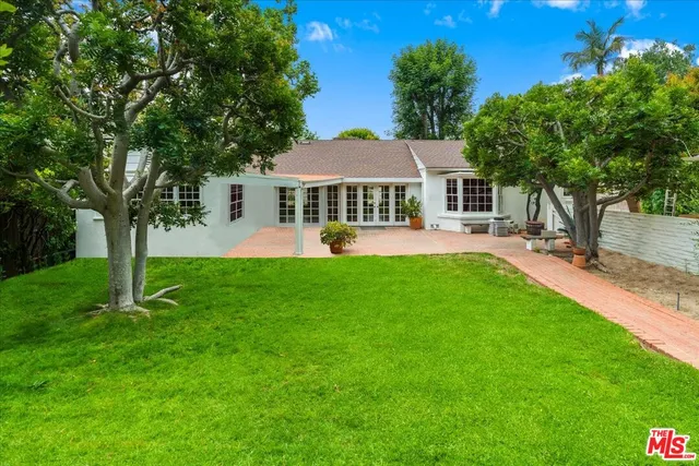 a front view of a house with a yard porch and garden