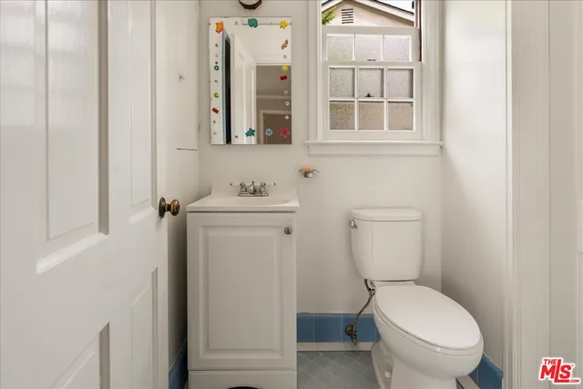 a white toilet sitting next to a bathroom sink