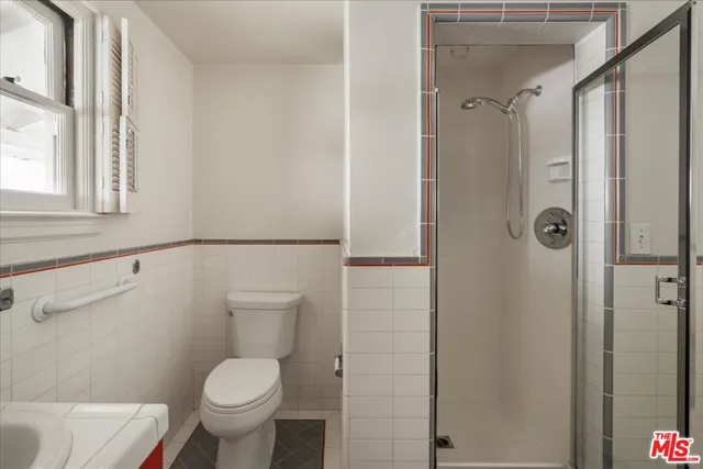a bathroom with a toilet and a shower