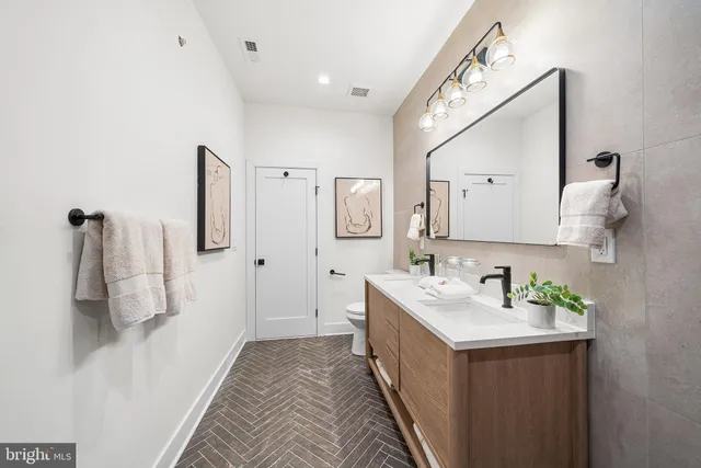 a bathroom with a sink vanity and mirror
