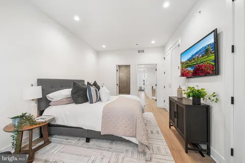 a bedroom with a bed and a potted plant