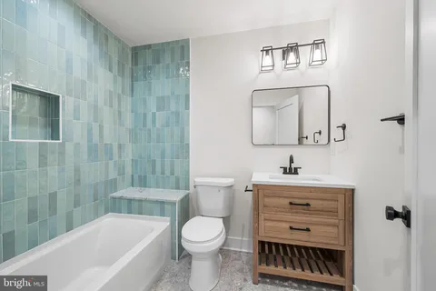 a bathroom with a toilet a sink and bathtub