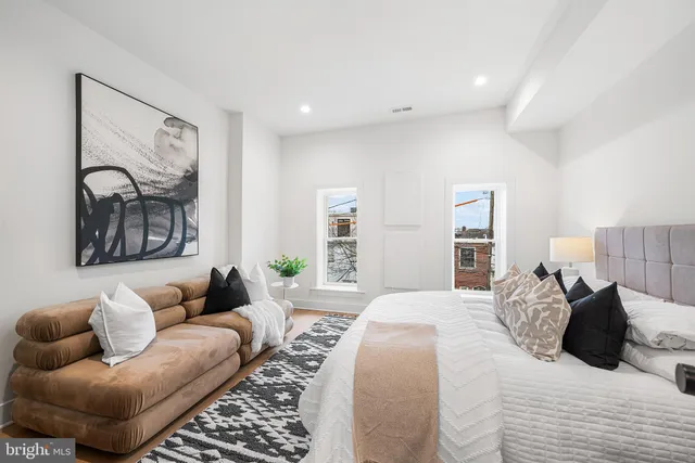 a bedroom with furniture and wooden floor