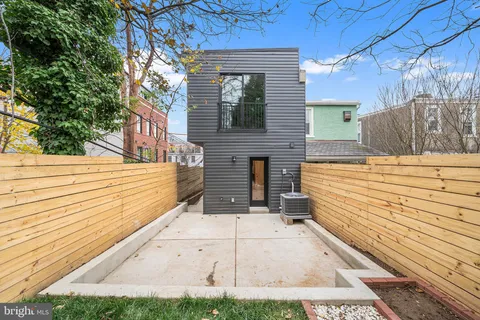 a view of a backyard with a large tree