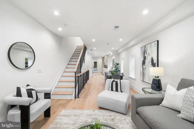 a living room with furniture and a mirror