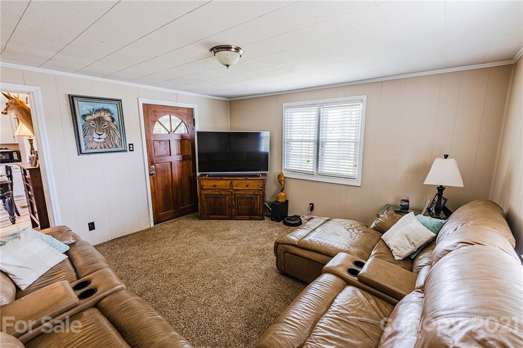 110 Edwards Road Mooresville, NC 28115 - Photo 11 of 39 a bed room with furniture and a flat screen tv
