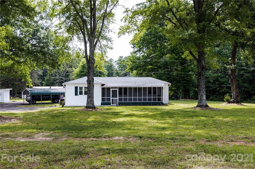 110 Edwards Road Mooresville, NC 28115 - Photo 22 of 39 a white house with a big yard and large trees