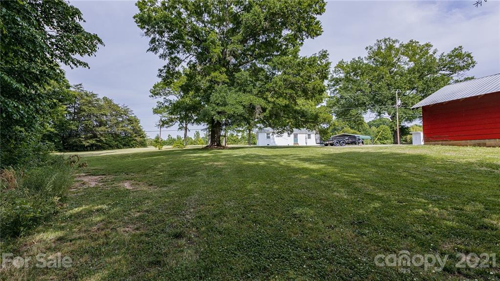 110 Edwards Road Mooresville, NC 28115 - Photo 35 of 39 a view of grassy field with benches and trees all around