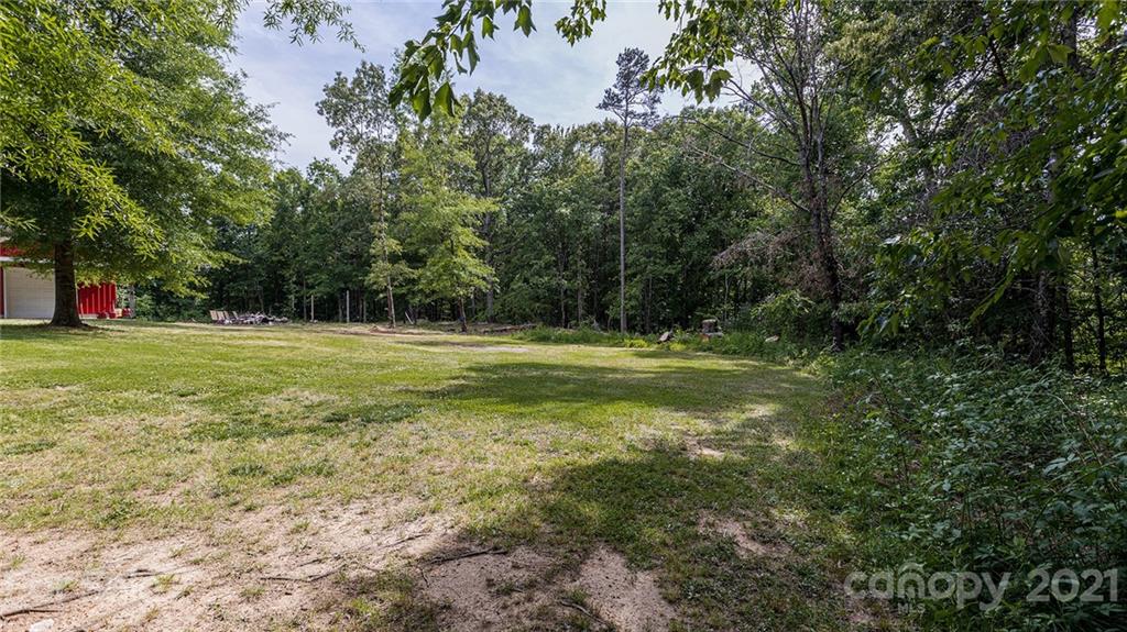 110 Edwards Road Mooresville, NC 28115 - Photo 36 of 39 a view of a grassy field with trees