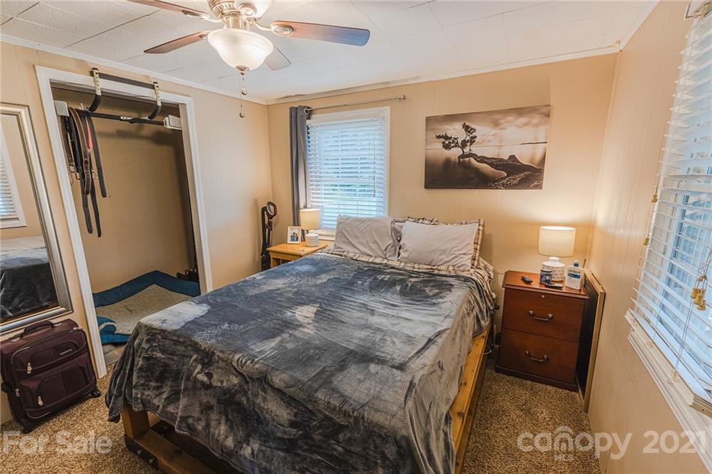 110 Edwards Road Mooresville, NC 28115 - Photo 9 of 39 a bedroom with a bed and a mirror