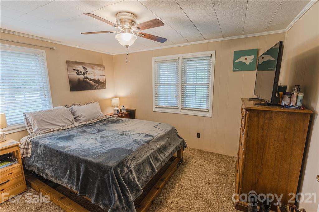 110 Edwards Road Mooresville, NC 28115 - Photo 10 of 39 a bedroom with a bed and a flat screen tv