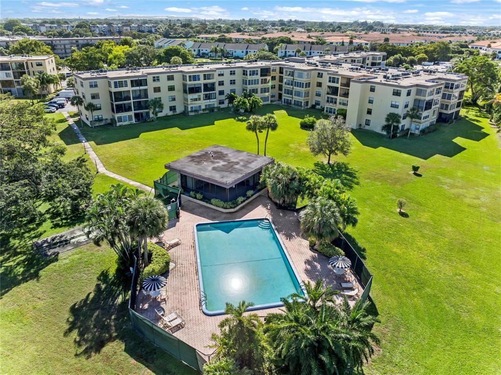 9355 Southwest 8th Street, Unit 109 Boca Raton, FL 33428 - Photo 1 of 4 an aerial view of a house with a swimming pool yard and mountain view