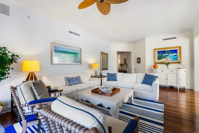 a bedroom with a bed a mirror and lamp on the table