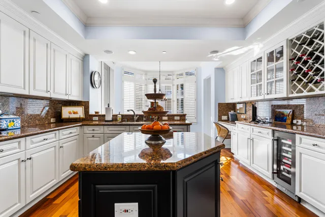 a kitchen with granite countertop cabinets stainless steel appliances and a counter top space