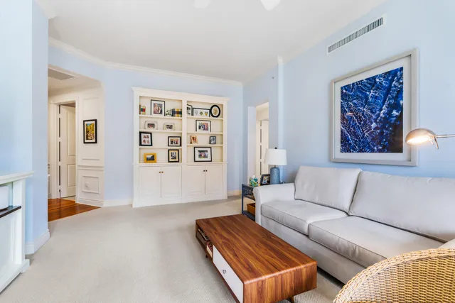 a view of a hallway view with wooden floor and living room