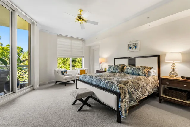 an aerial view of a city with lots of residential buildings ocean and mountain view in back