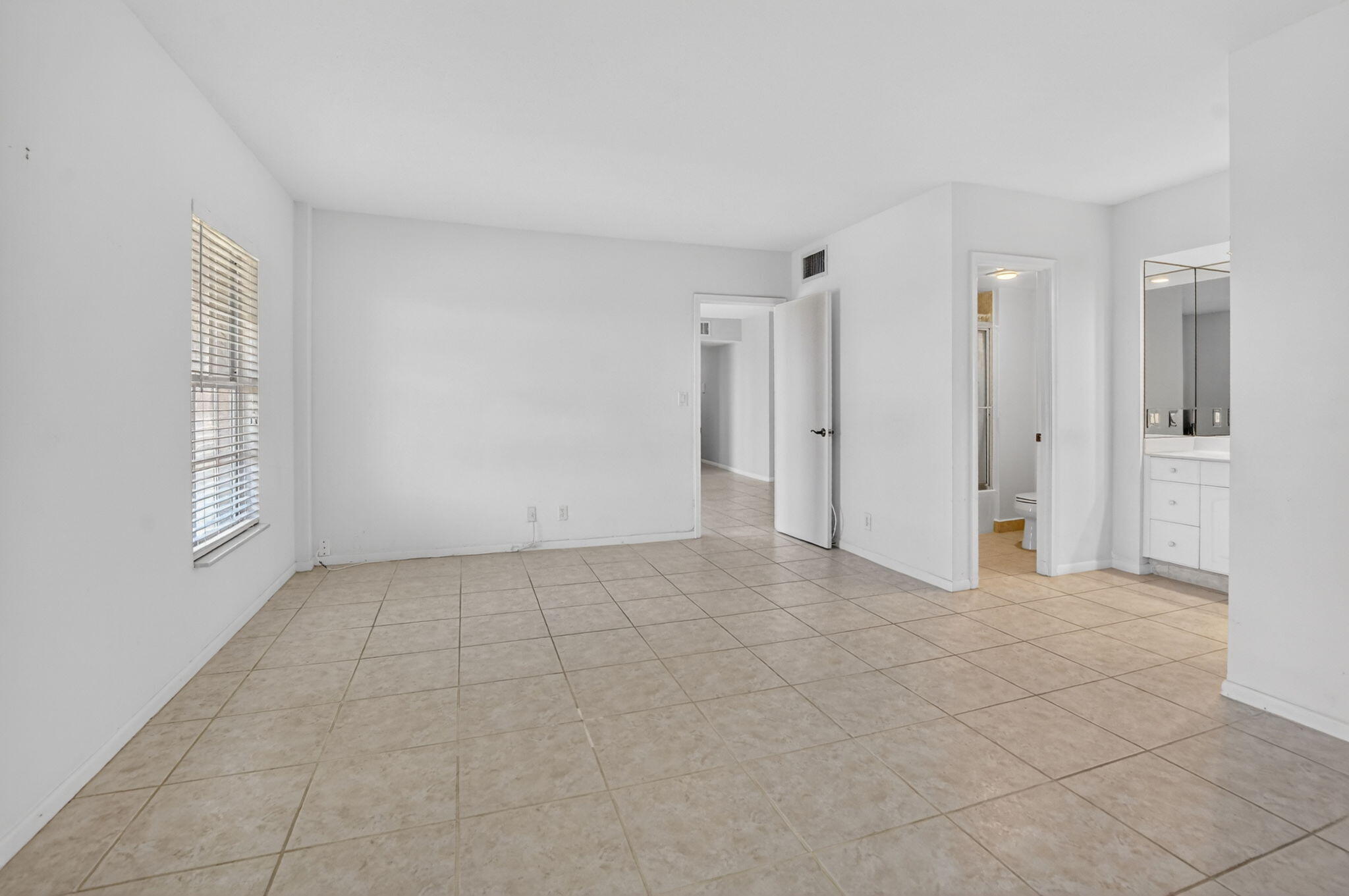 250 Northeast 20th Street, Unit 5220 Boca Raton, FL 33431 - Photo 15 of 40 a view of an empty room with window and chandelier fan