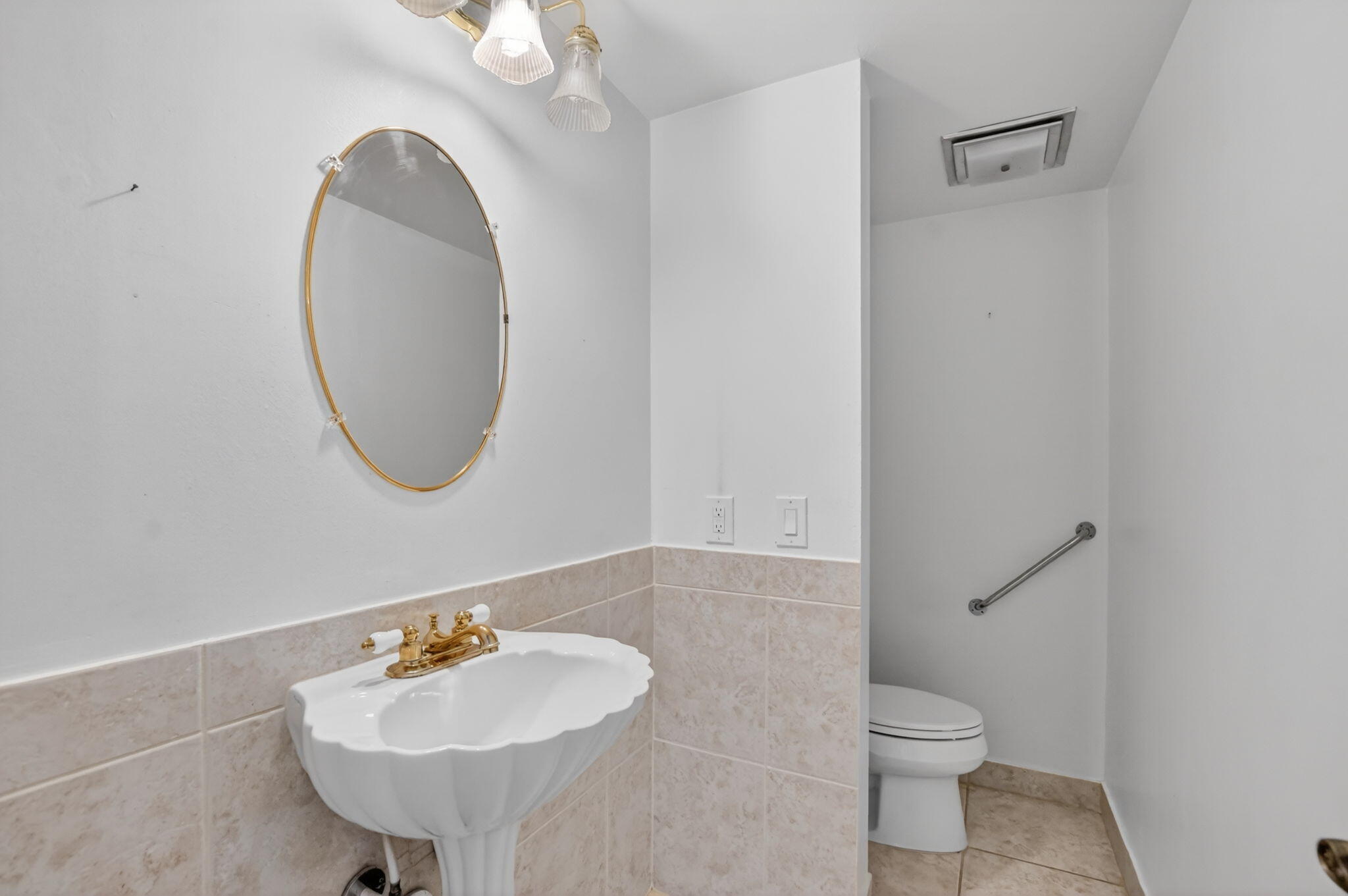 250 Northeast 20th Street, Unit 5220 Boca Raton, FL 33431 - Photo 18 of 40 a bathroom with a toilet a sink and a mirror