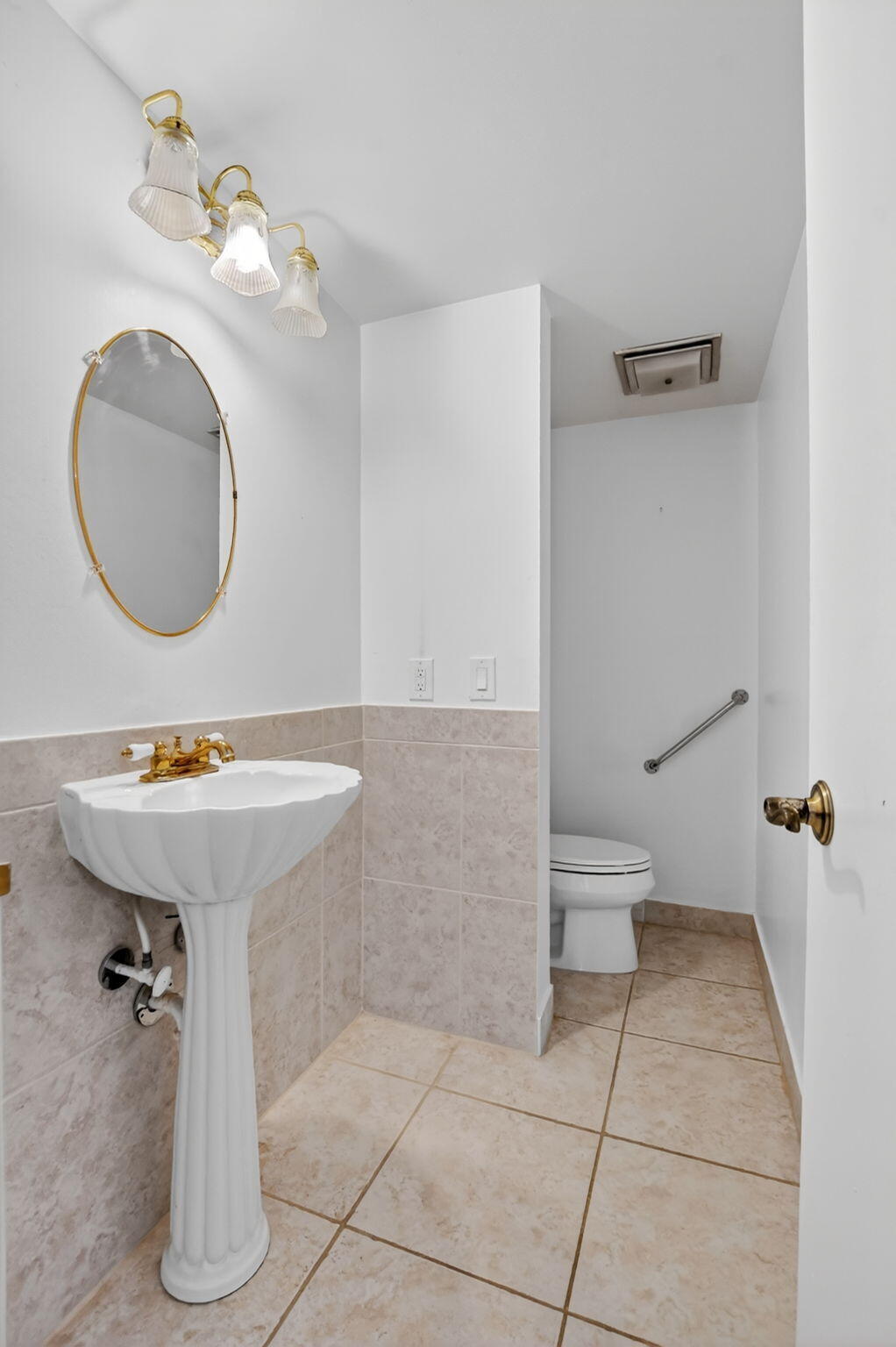 250 Northeast 20th Street, Unit 5220 Boca Raton, FL 33431 - Photo 19 of 40 a bathroom with a sink a toilet and mirror