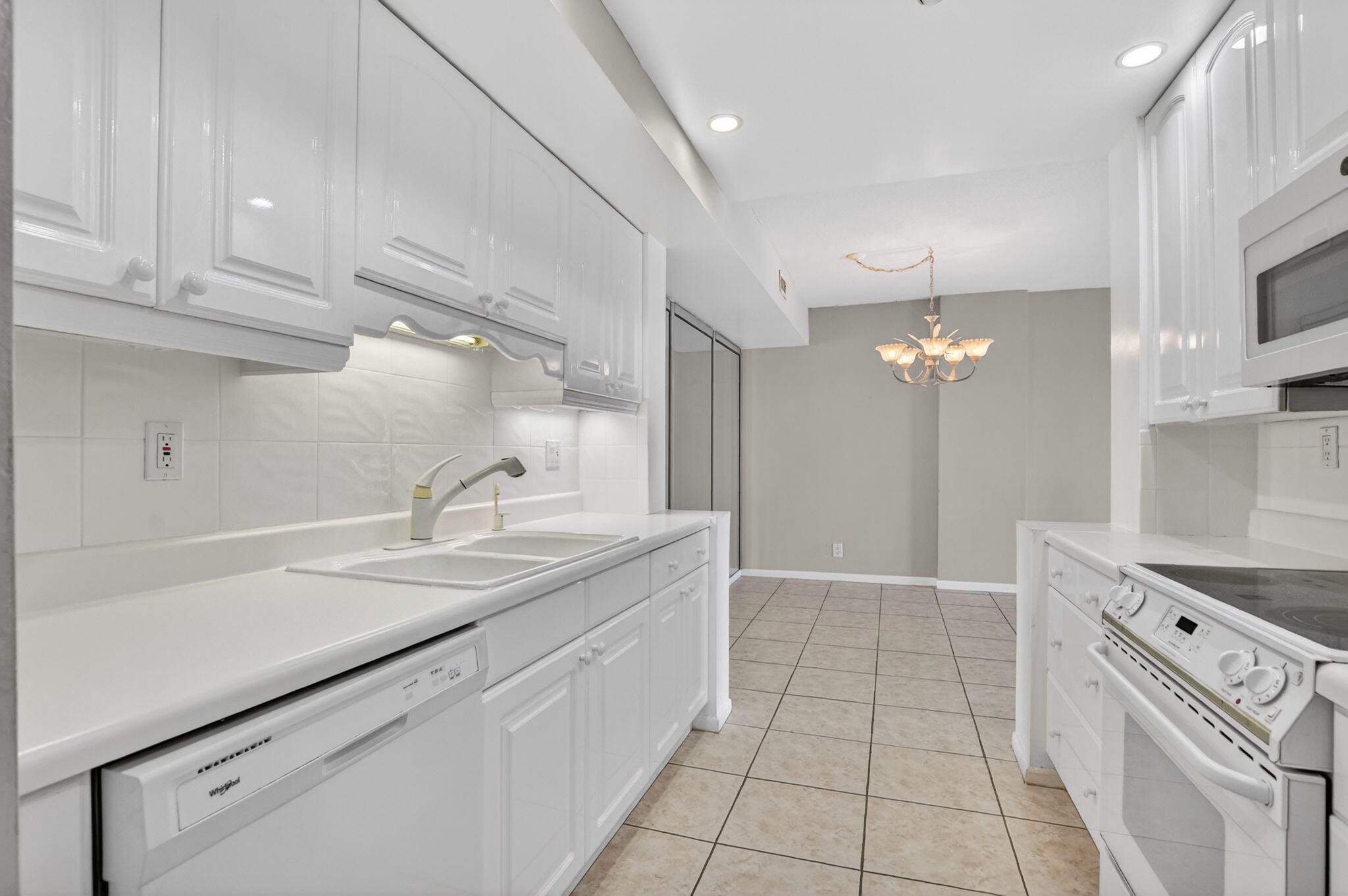 250 Northeast 20th Street, Unit 5220 Boca Raton, FL 33431 - Photo 4 of 40 a spacious bathroom with a granite countertop sink a toilet a mirror and vanity