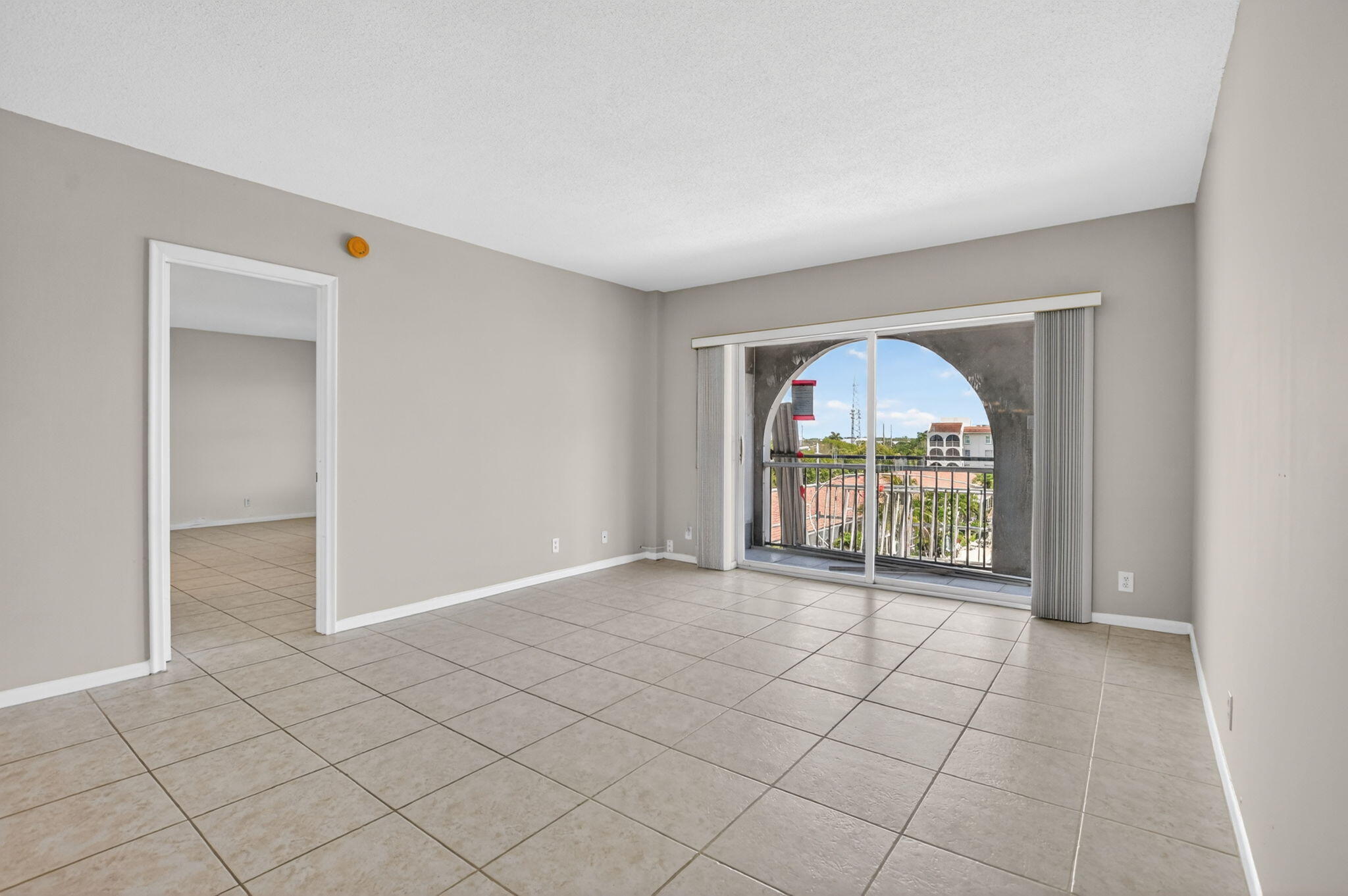 250 Northeast 20th Street, Unit 5220 Boca Raton, FL 33431 - Photo 9 of 40 an empty room with floor to ceiling window and windows