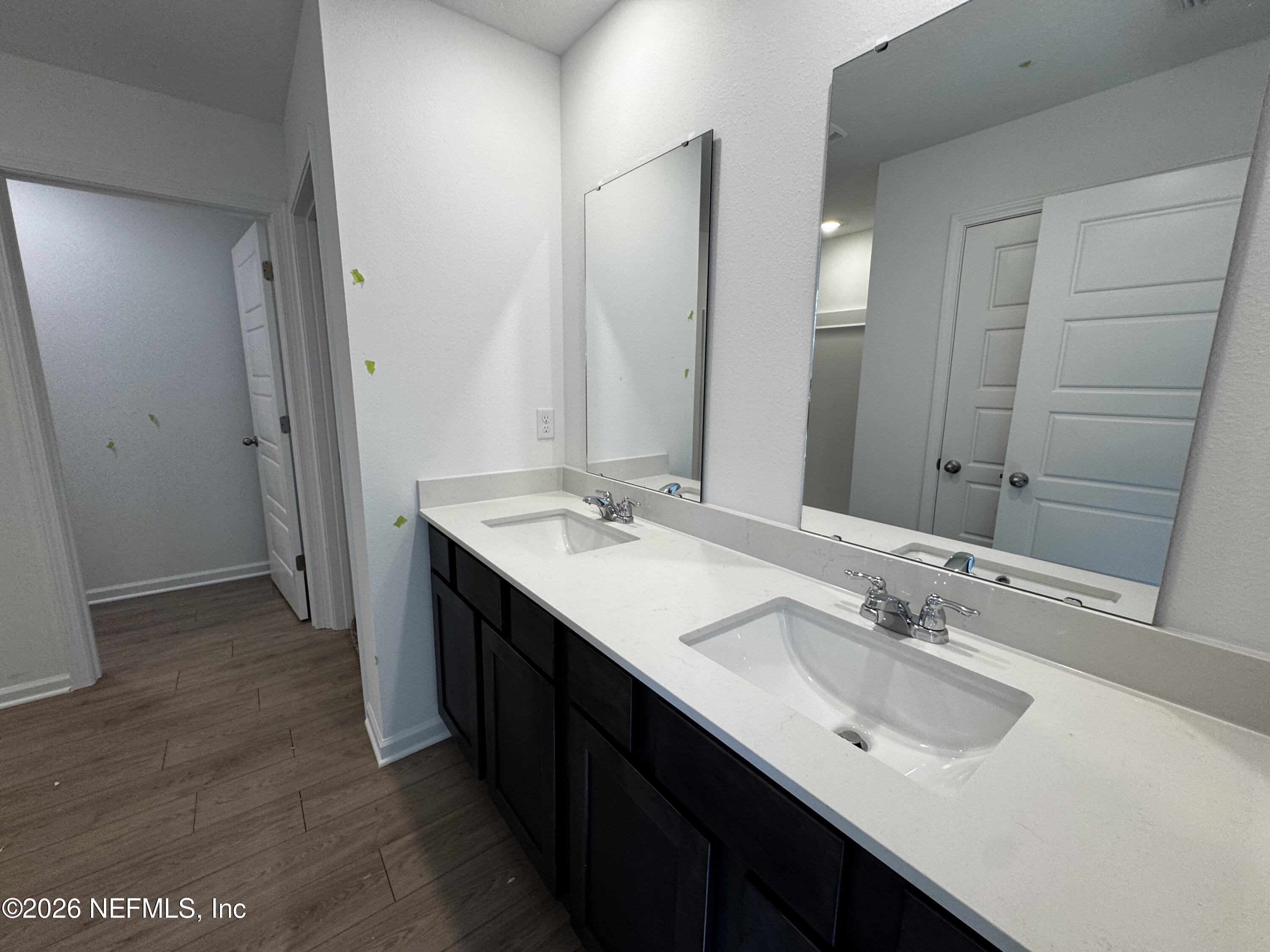 12390 Great Eagle Road Jacksonville, FL 32219 - Photo 17 of 69 a bathroom with a double vanity sink and mirror