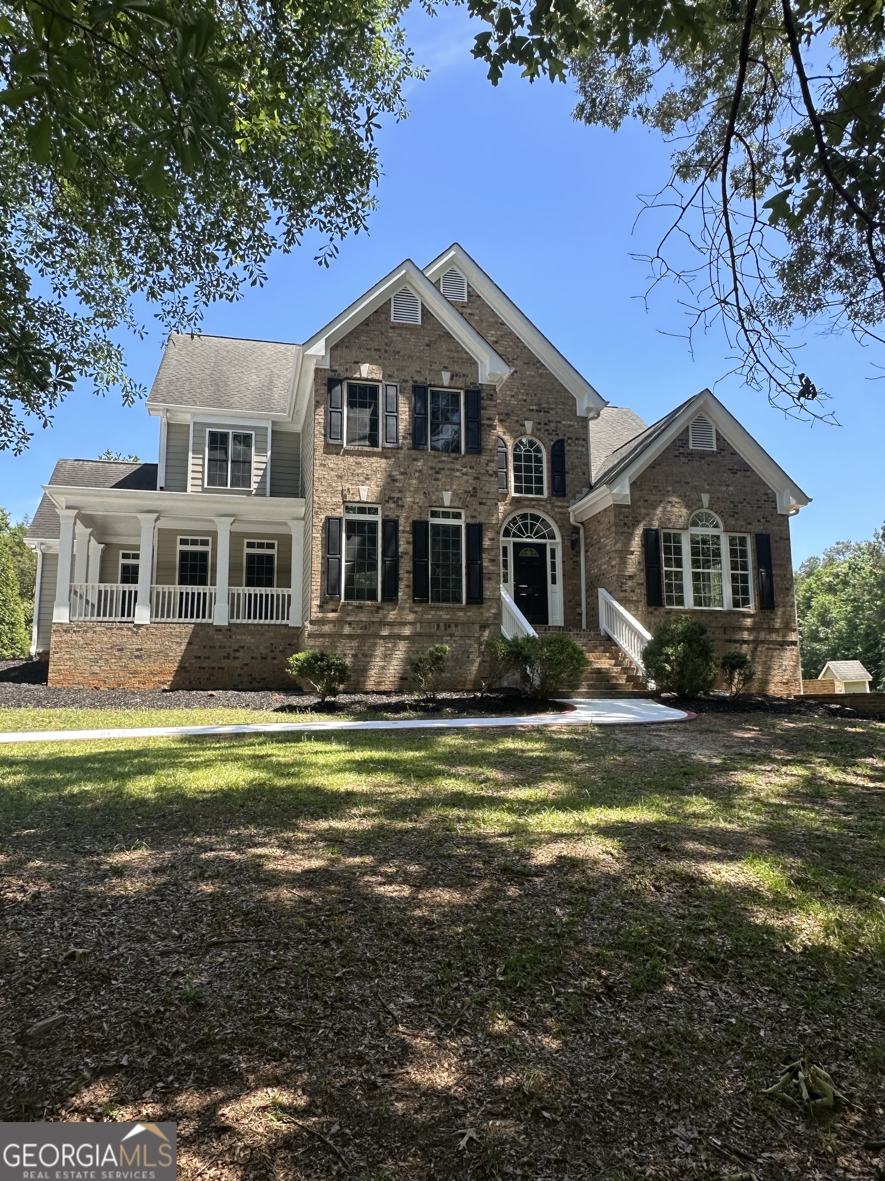 65 Spratlin Way Hull, GA 30646 - Photo 2 of 35 a front view of a house with a garden