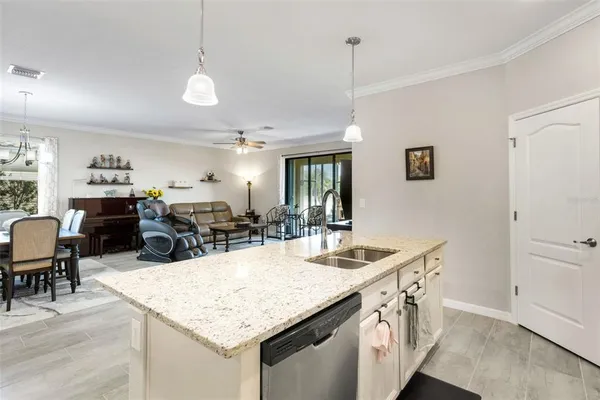 a kitchen with stainless steel appliances granite countertop a sink and a refrigerator
