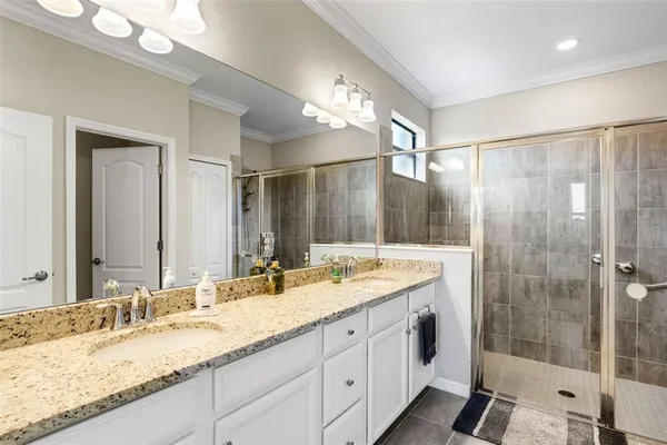 a bathroom with a granite countertop sink mirror and double