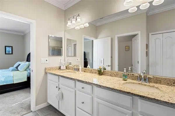 a bathroom with double vanity sinks and a mirror