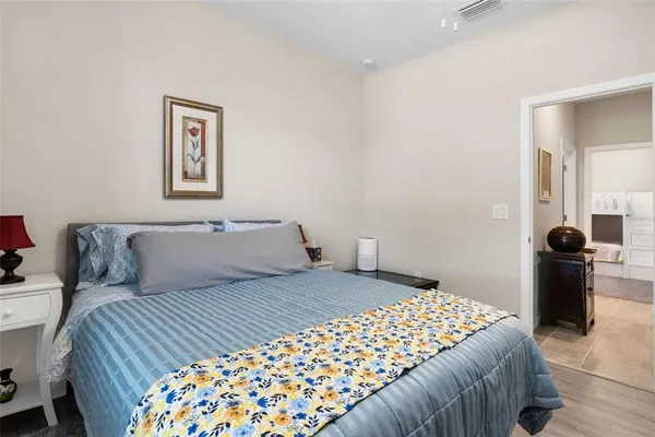 a bedroom with a large bed and a lamp